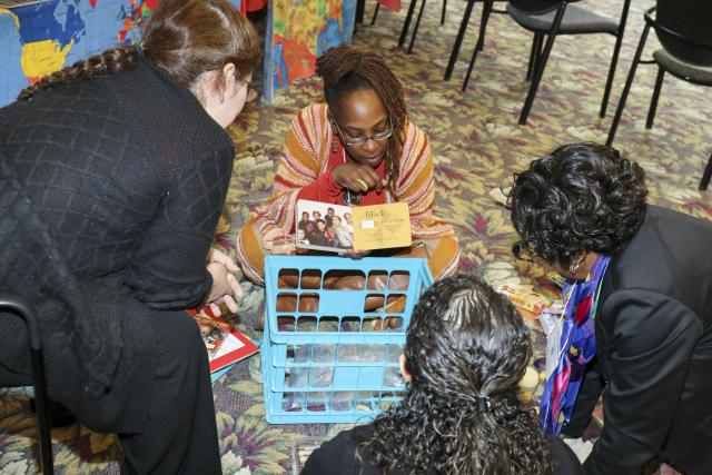 A mentor leads a small group discussion on culturally responsive practices.