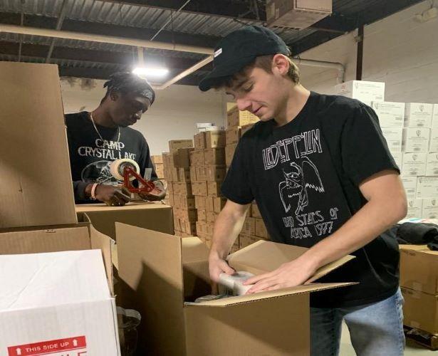 DormlyBox co-founders Jaelen Hymes and Jared Shiffman pack boxes