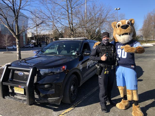 Police sergeant poses with Kean Cougar