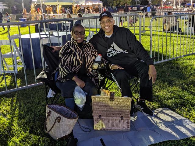 An older couple with a picnic basket at the Jazz & Roots Music Festival.