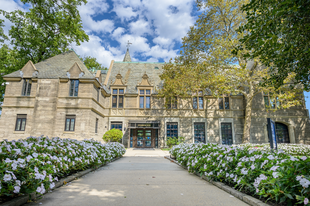 Kean Hall at Kean University, with a path decorated with flowers leading to it.