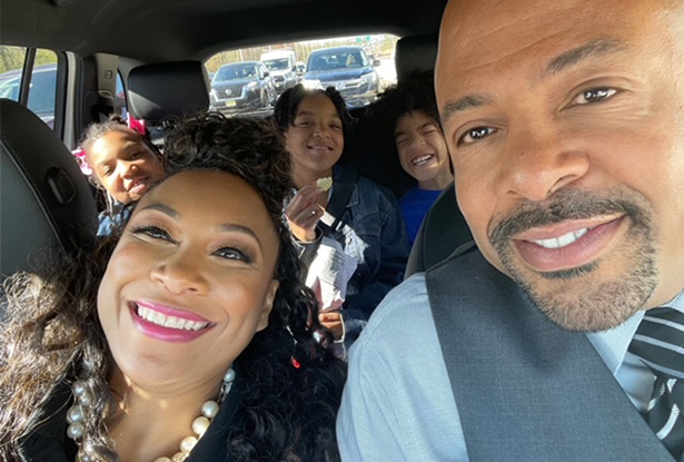 Roberta and Alvin Freeman in the front seat of car, with their three children behind them.