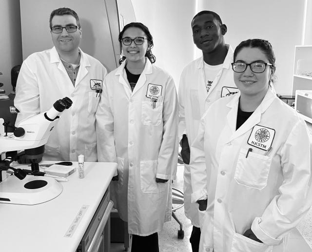 Matt Niepielko is pictured with three Kean student researchers in the lab