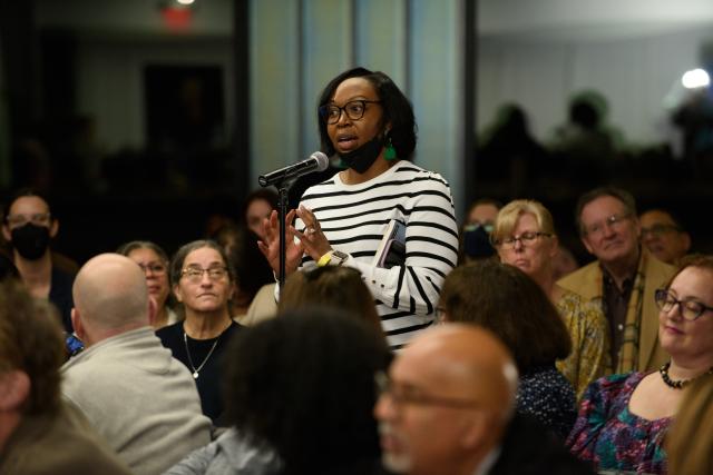 Woman in crowd asks question at McBride lecture