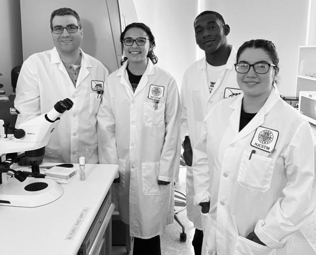 Kean Assistant Professor Matt Niepielko, Ph.D., left, in the lab with (l-r) student researchers Dominique Doyle, Ahad Shabazz-Henry, and Gisselle Hidalgo