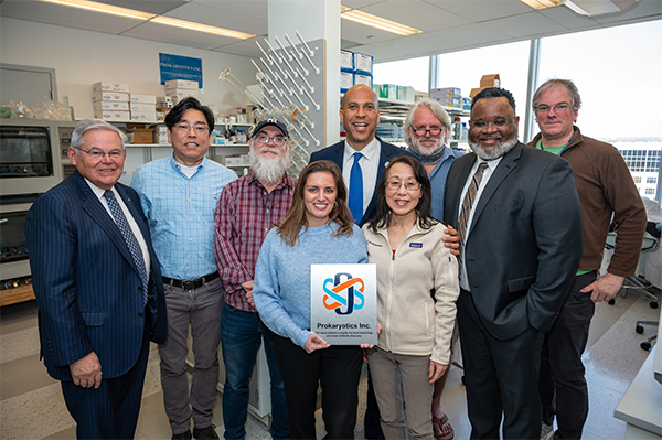 Senators Booker and Menendez pose with the scientists of Prokaryotics