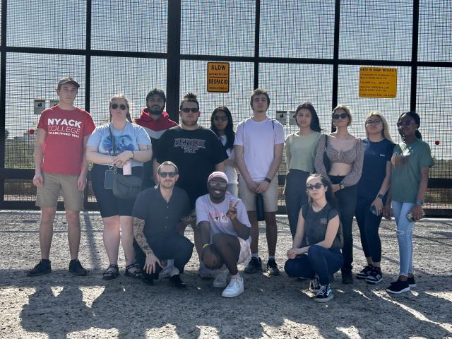 Kean students stand at the U.S./Mexico border fence in Texas