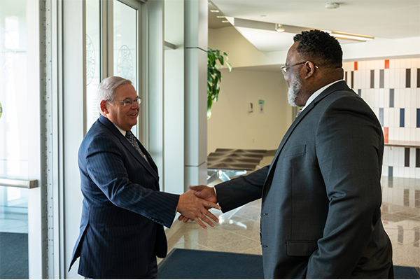 Kean President Repollet greets Senator Menendez with a handshake at the door of the STEM Building