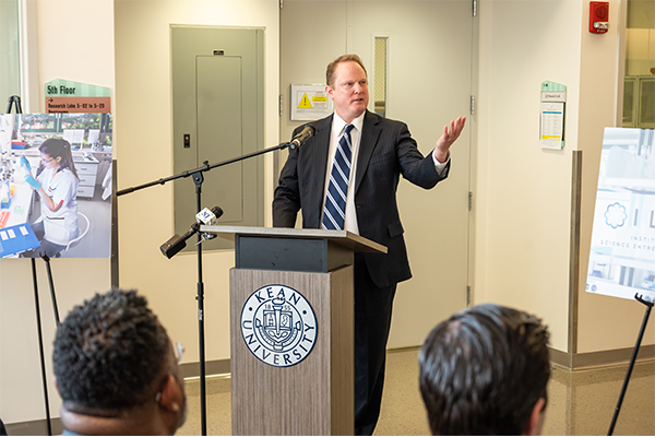 ILSE President Tom Richardson gestures while speaking at a podium