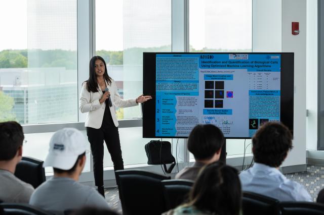 Student Bianca Ortega presents her research to Michio Kaku, Ph.D.