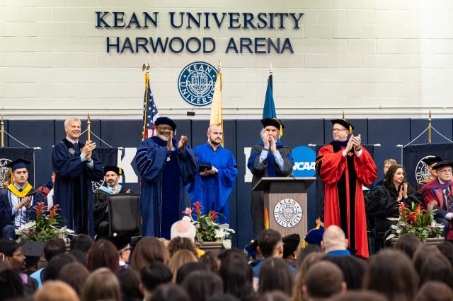 Kean top administrators applaud the graduates from the dais