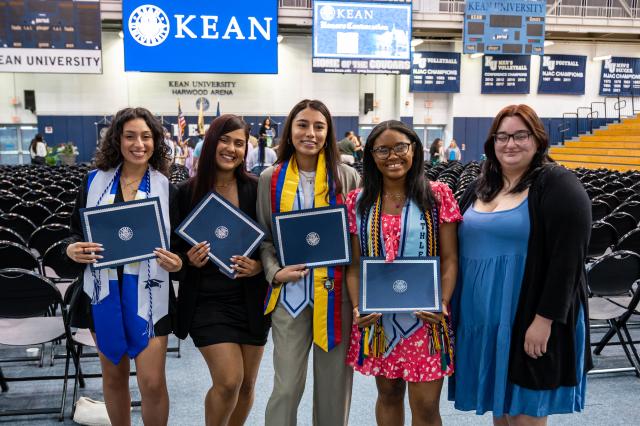 Smiling honors graduates pose at Harwood