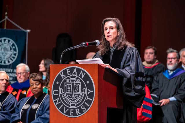 Jodi Kantor dressed in black robes at the podium