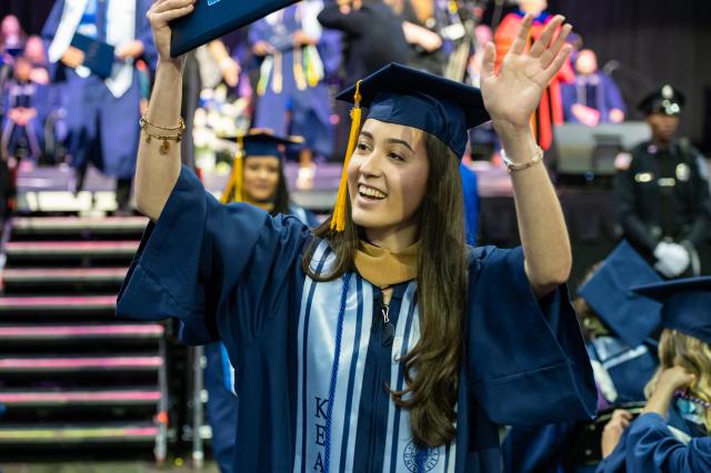 Kean grad waves at the crowd