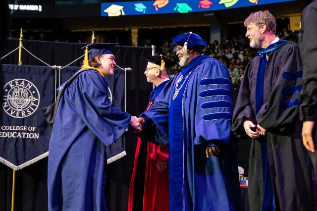 President Repollet shakes a graduate's hand