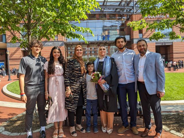 Hafitha Saadeh, surrounded by her family, at Kean's 2023 Graduate Commencement