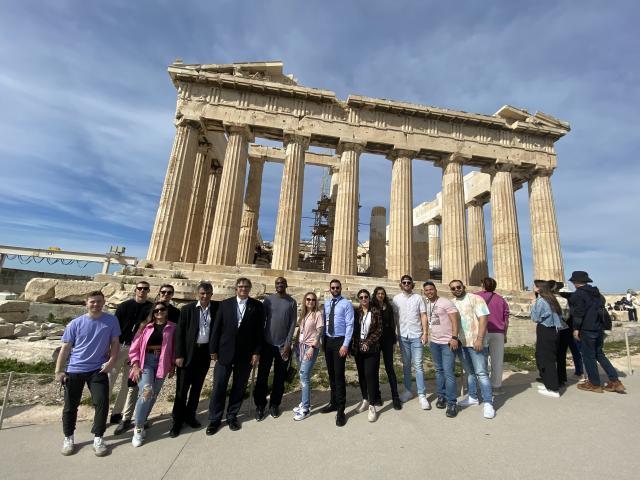 Students standing in front of the Acropolis 