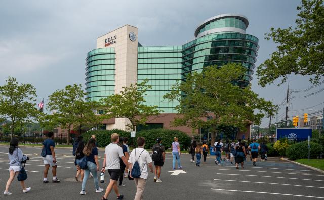 Students walk across the Kean campus during orientation. GLAAB is visible in background.