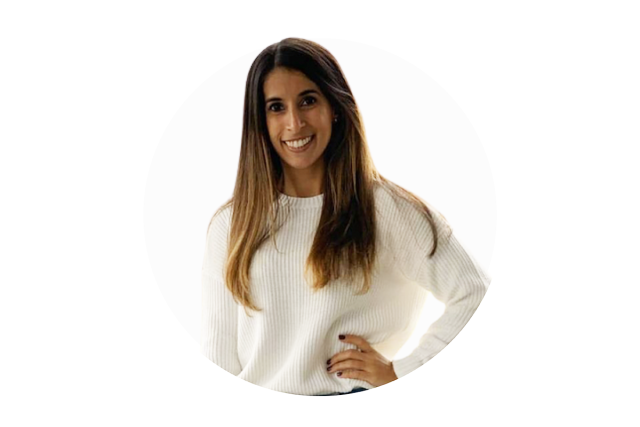 A young woman with long brown hair wearing a white sweater.