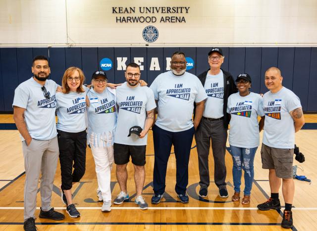 Kean employees gather with President Repollet in Harwood Arena