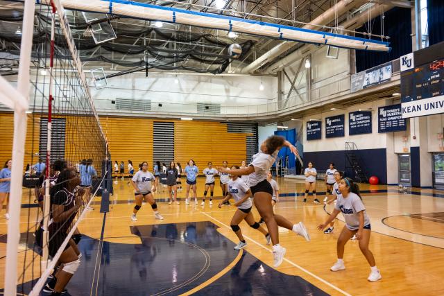 Students play volleyball at Harwood Arena in Kean's KUBS volleyball clinic.