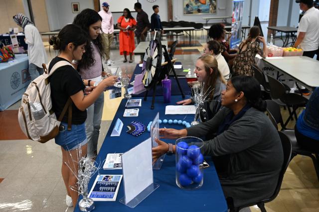 Students talk to staff at the Kean Wellness Expo