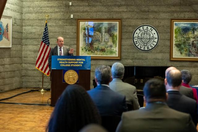 State Senator Joe Cryan, at a podium with the sign Strengthening Mental Health Support for College Students