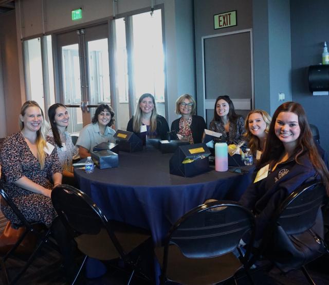 Kean students and faculty seated at a round table in the north ave academic building during NJOTA's 2023 conference