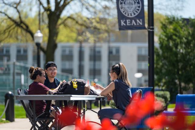 Kean students chat near the quad on a spring day