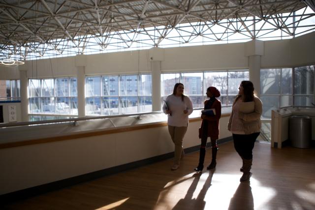 Atmospheric photo of students walking in a modern classroom building