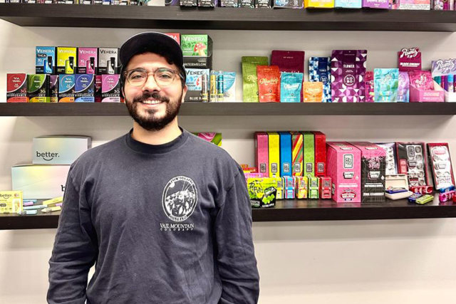 Mike Kapotis stands in front of a display of products his company designed