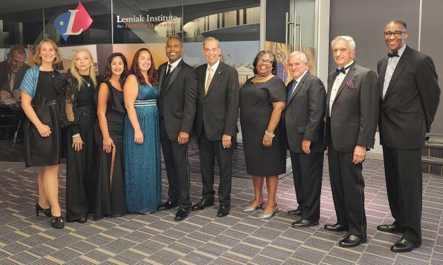 Group photo of alumni association members in formal attire