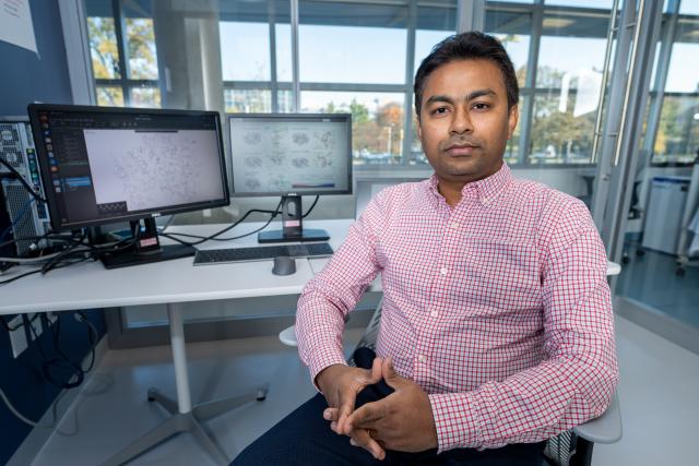 Supratik Kar, Ph.D. is pictured at the computer in his office at Hennings