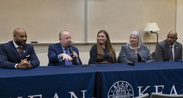 Panelists in the Public Affairs career forum speak to students at a dais