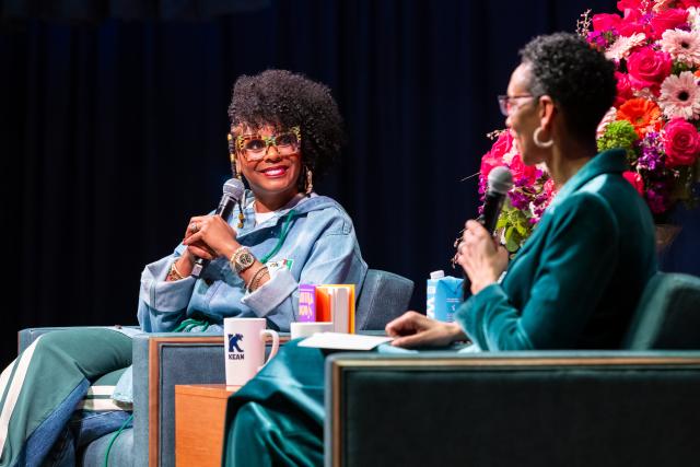 Tabitha Brown faces camera, talking with Darlene Repollet