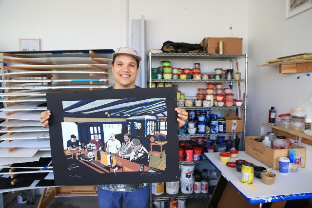 Artist Ricardo Roig displays a piece of his art in his studio