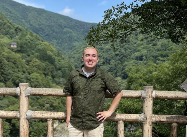 Kevin Vega is pictured in a lush, mountainous setting in Japan