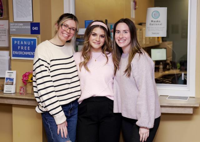 Three young women, Kean grad students in speech language pathology, at the communication disorders clinic