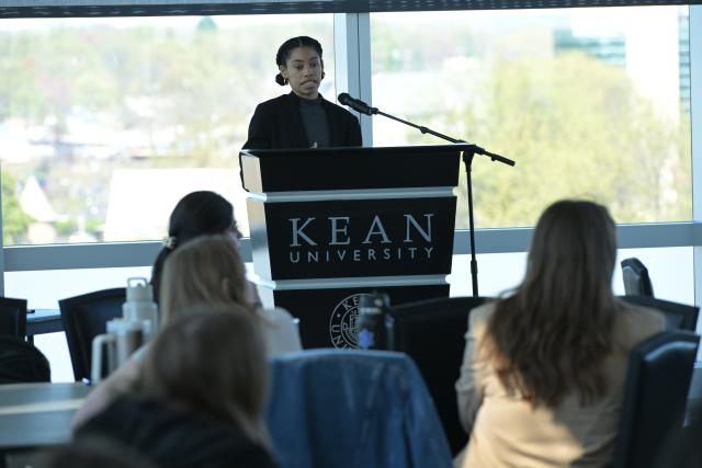 Kean student presents at lectern