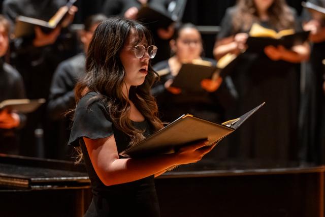 A soloist performs with the Kean concert choir