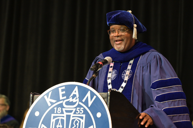 Kean University Lamont O. Repollet speaks from a podium at Undergraduate Commencement.