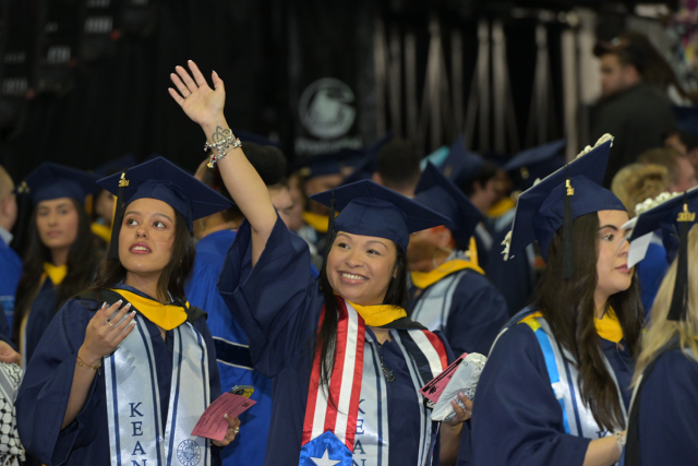 Kean University graduates wave to their families as they processed into Undergraduate Commencement.