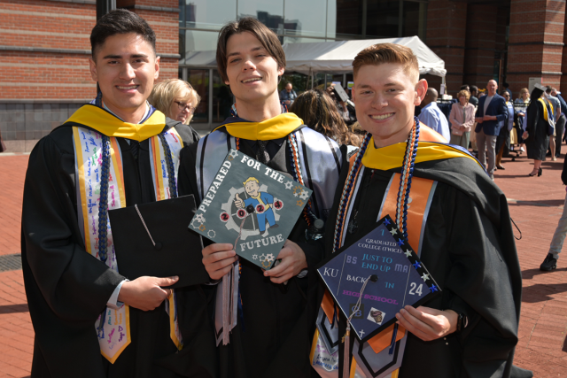 Three friends at graduate commencement