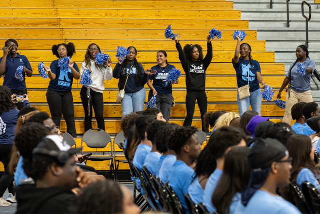 Kean students and staff, with pom-poms, cheer the Class of 2028 from the stands at Harwood Arena.