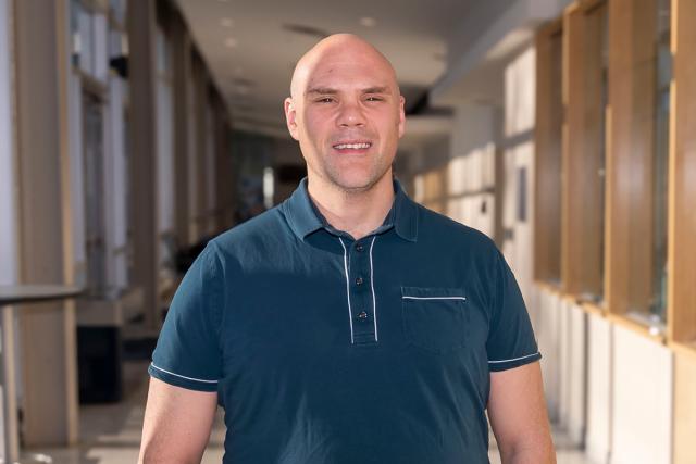 Kean's new wrestling coach Chris DiSanto will lead the men's and women's wrestling programs. He's pictured in the hall of Harwood