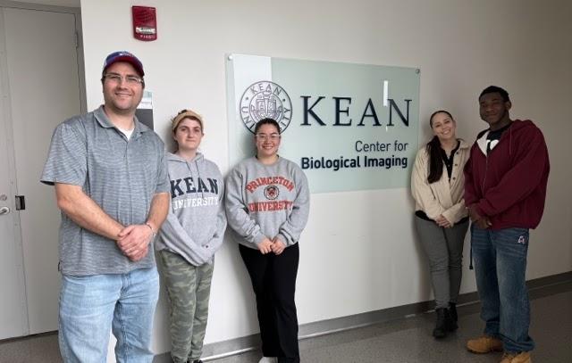 Niepielko lab members in front of sign