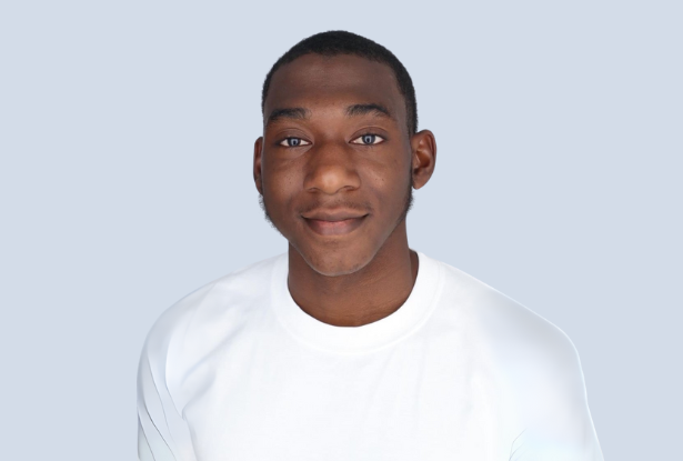 Smiling Black male with short hair wearing a white shirt