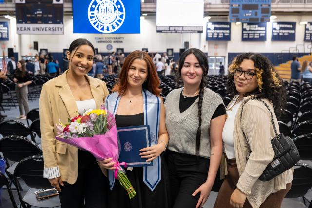 Happy honors graduate with friends and family