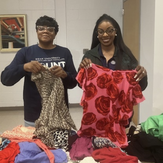 Ms. Harris and Dr. Dean organizing clothes for students looking for a great find.