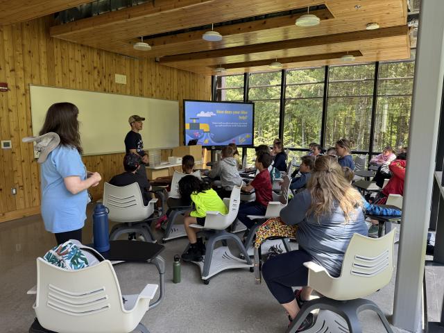 Group of students in a classroom setting learning about water quality